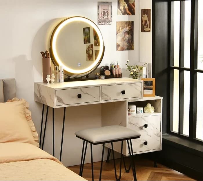 white vanity with leatherette seat and round lit mirror