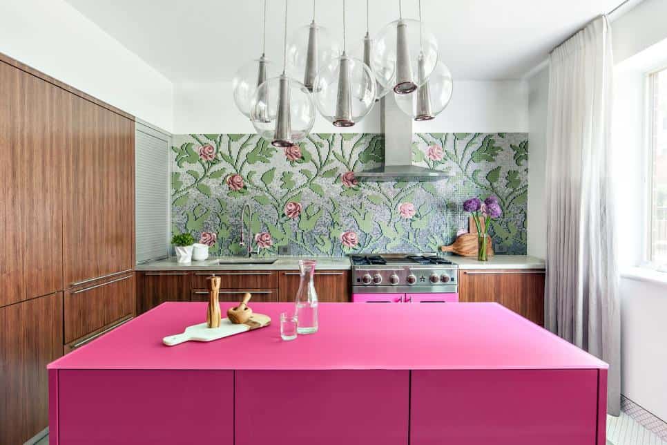 Modern kitchen design with decorative lighting and pink cabinet
