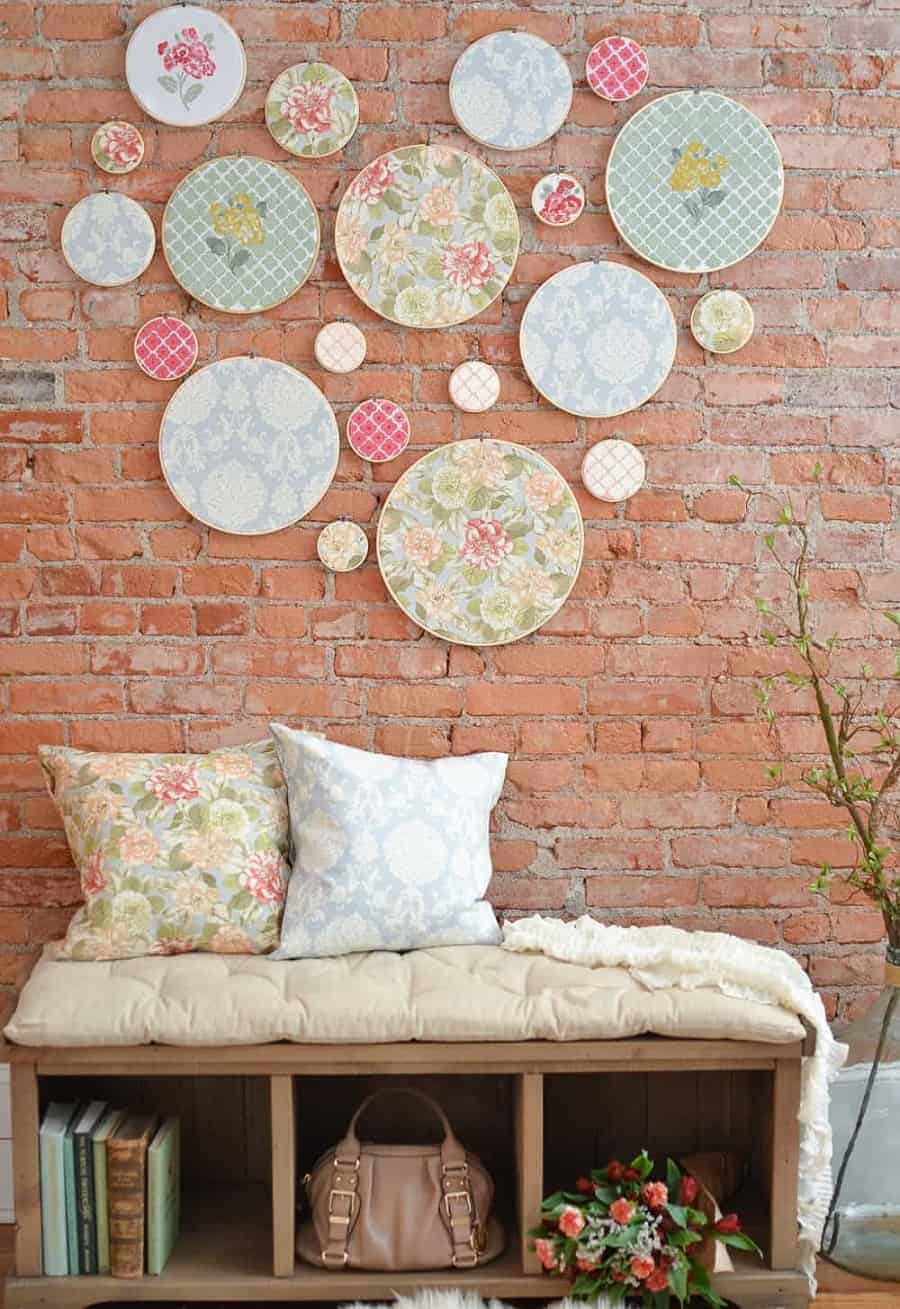 a brick background with embroidery hoops and lace