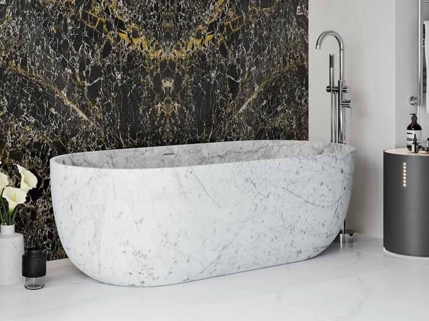 White marble free standing bathtub with black marble wall