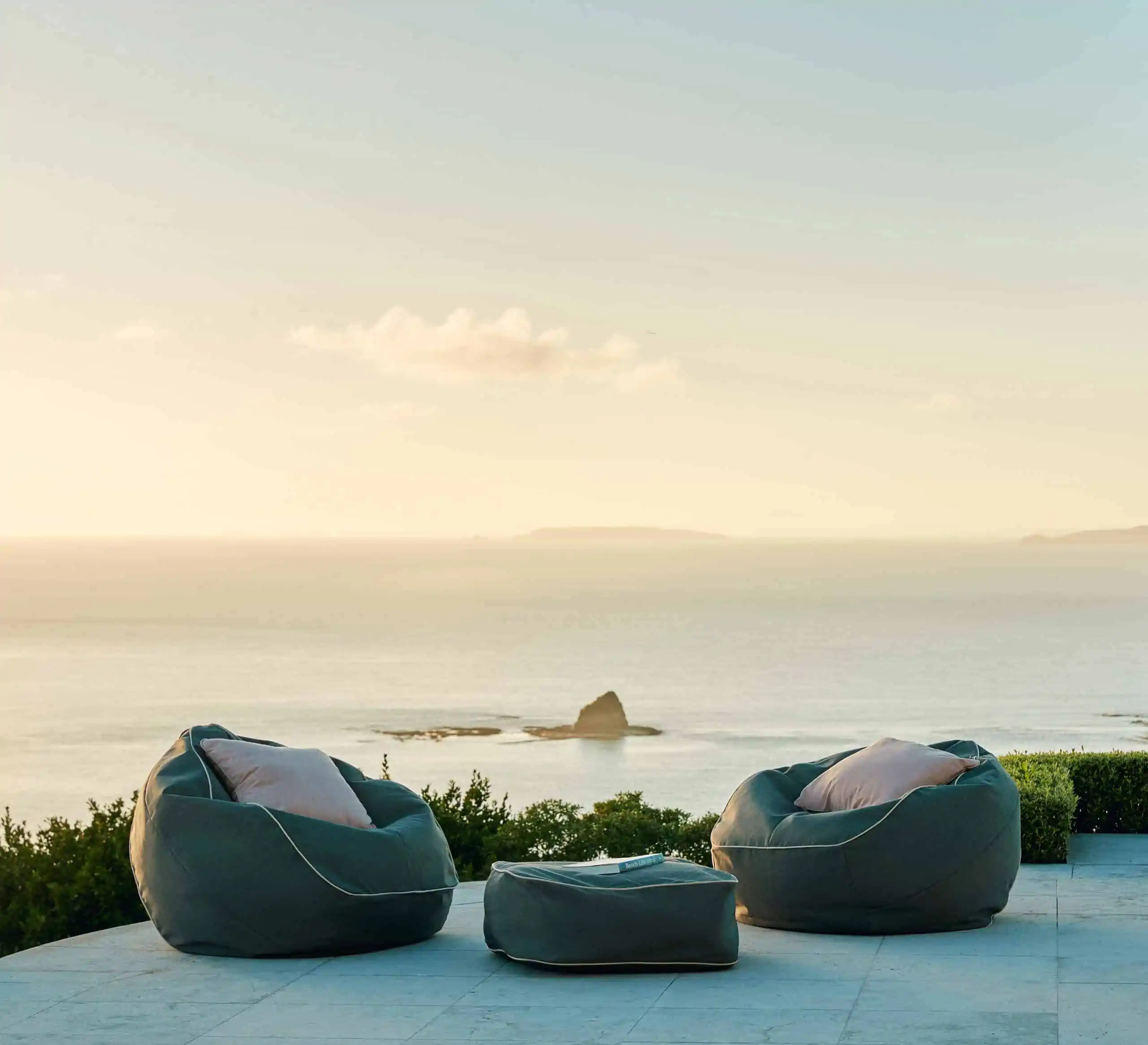 two black round beanbags placed outdoors near the deck