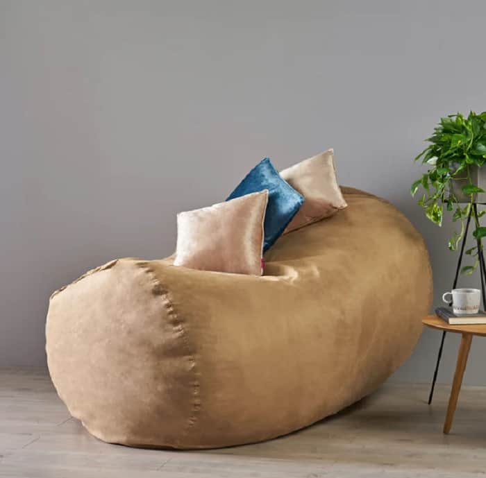 tan leather long beanbag for adults eith colourful cushions