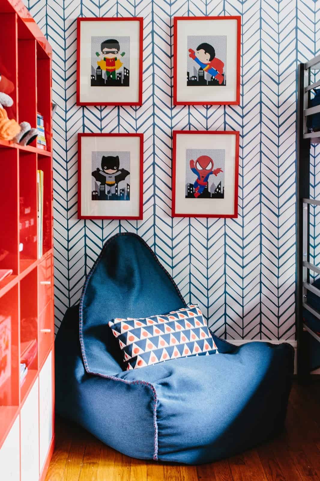 blue bean bag with printed wallpaper and red bookshelf