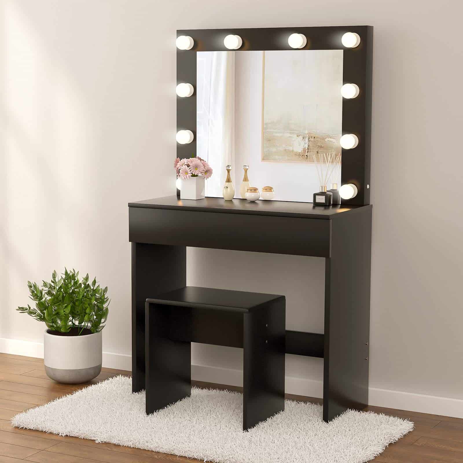black vanity table with lights and black stool with white walls and white carpet