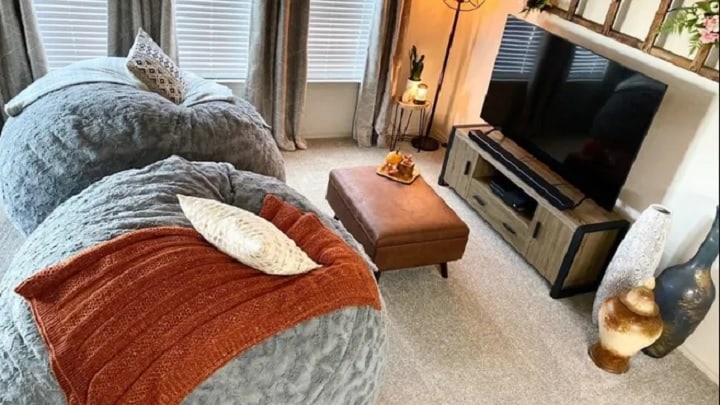 grey fur bean bag chairs with brown leather coffee table and tv unit