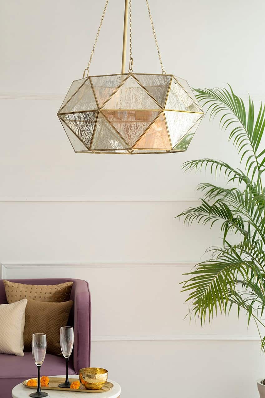 hanging lights with a plant and brown sofa