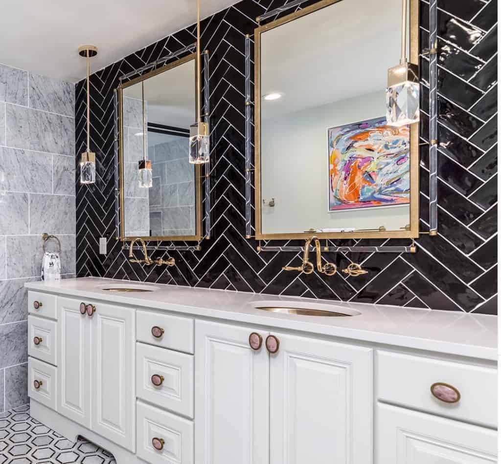 marble top sink with black chevron tiles and gold detailing 