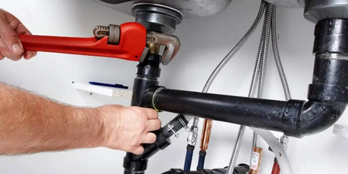 plumbing professional servicing the pipe system