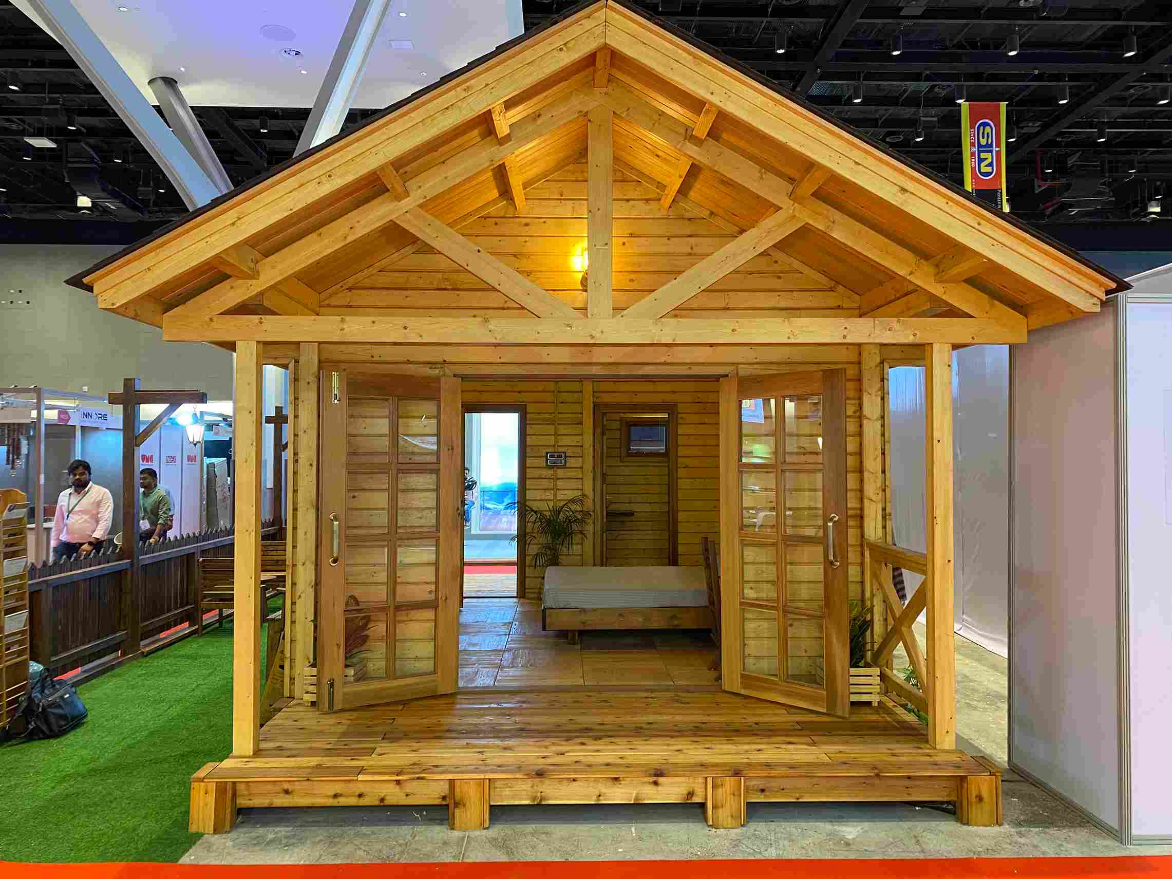 brown house with green rug, sustainable home by canadian wood displayed at index fair 2022