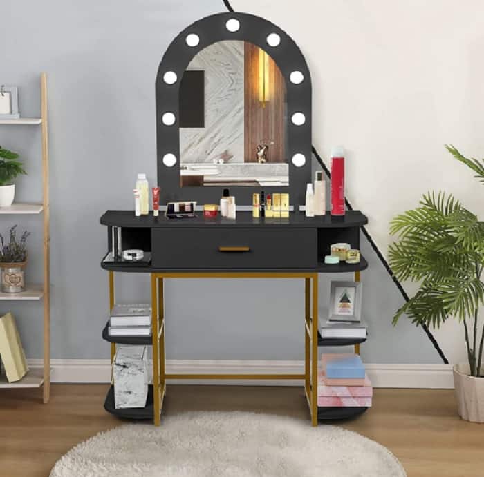 white walls with black vanity and gold detailing with lights