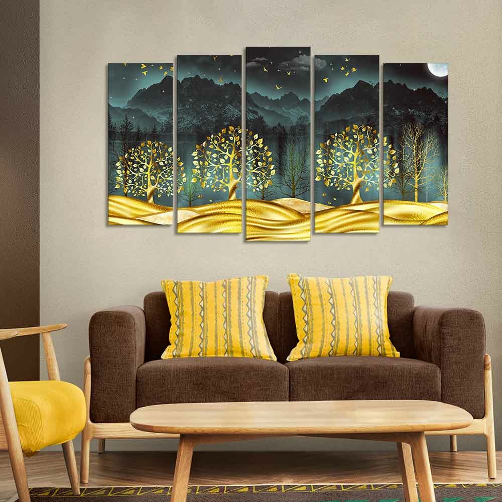 Wall painting of golden trees in dark forest of five pieces set placed over a sofa set in the living room