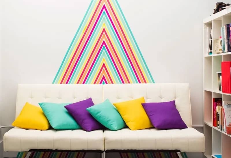 Colourful Washi tape wall with white sofa and white bookshelf wall decoration diy