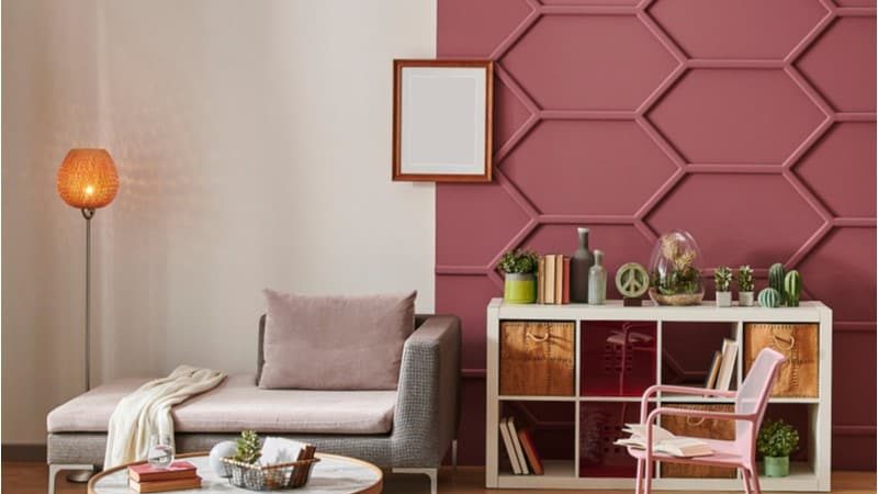 burgundy wall paint in a living room with sofa, table and shelf