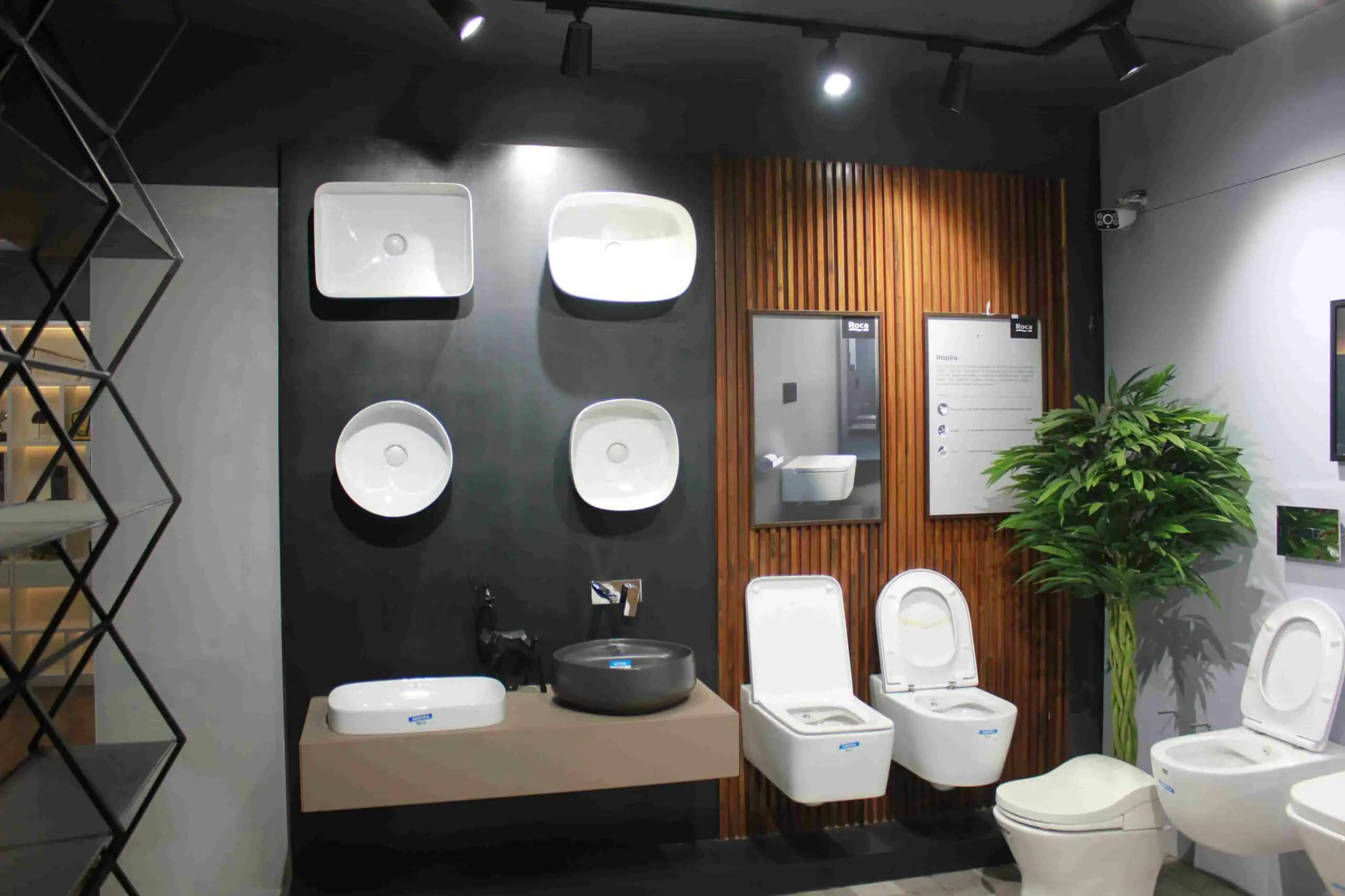grey wall with white sinks and toilets