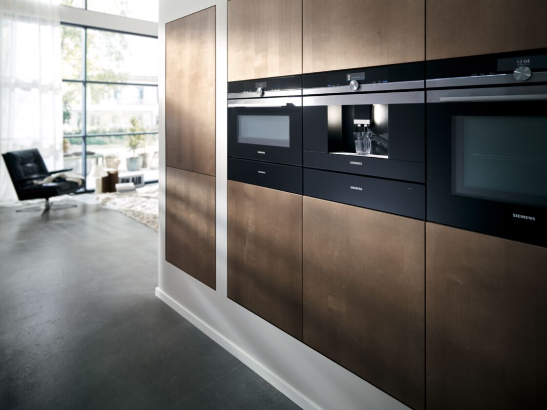 siemens built in microwave, convection, and combi steam oven arranged in horizontal layout in a kitchen