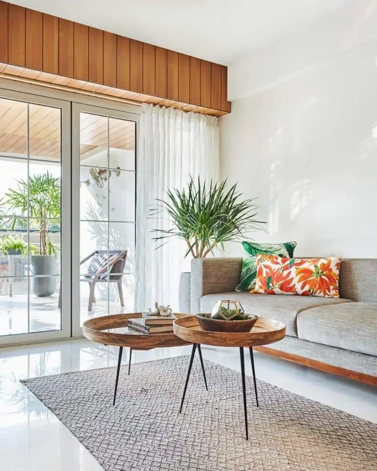 white modern luxury living room design with grey sofa, sliding glass door, and wood table; minimalist home interiors