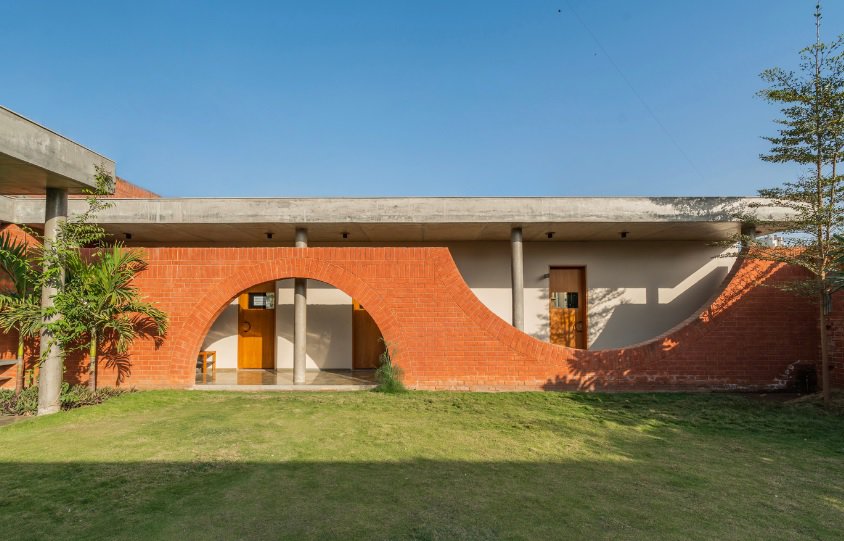house with bricks wrapped around it in an unusual design