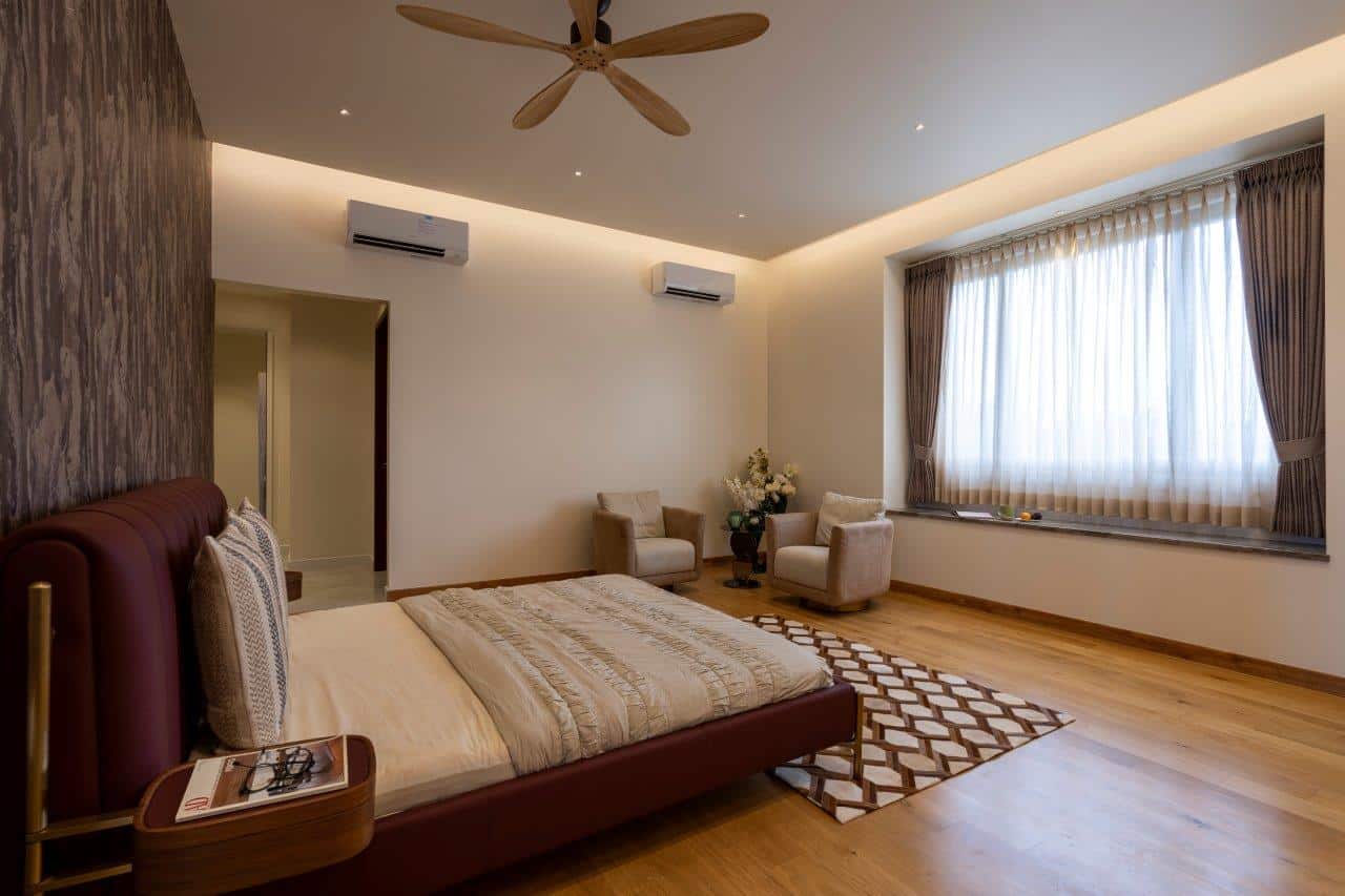 bedroom with brown floors bed and fan