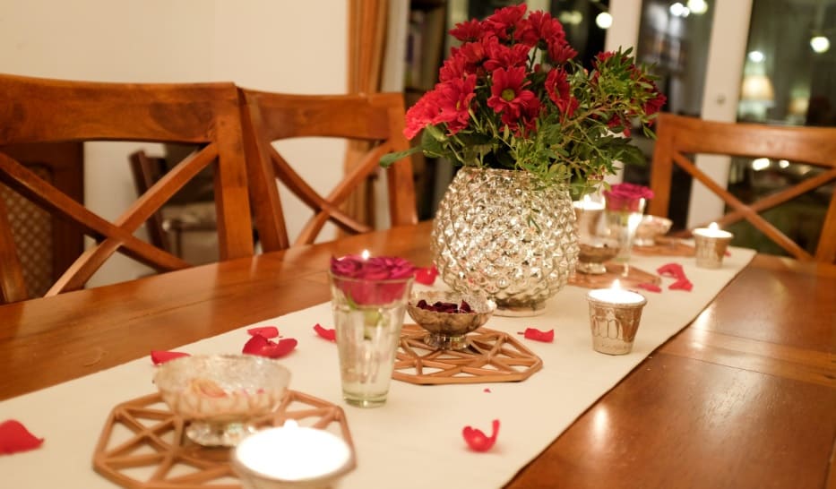 table layout with flowers petals and candles