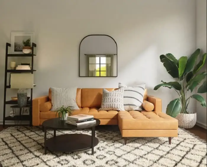 light brown colour couch with cream rug and white mirrored wall