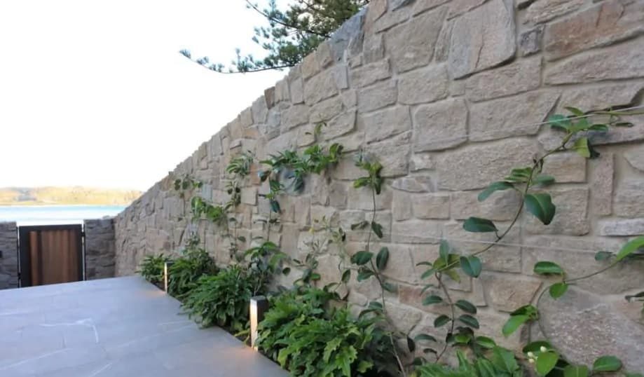 cladding compound wall design using stone tiles in beige colour