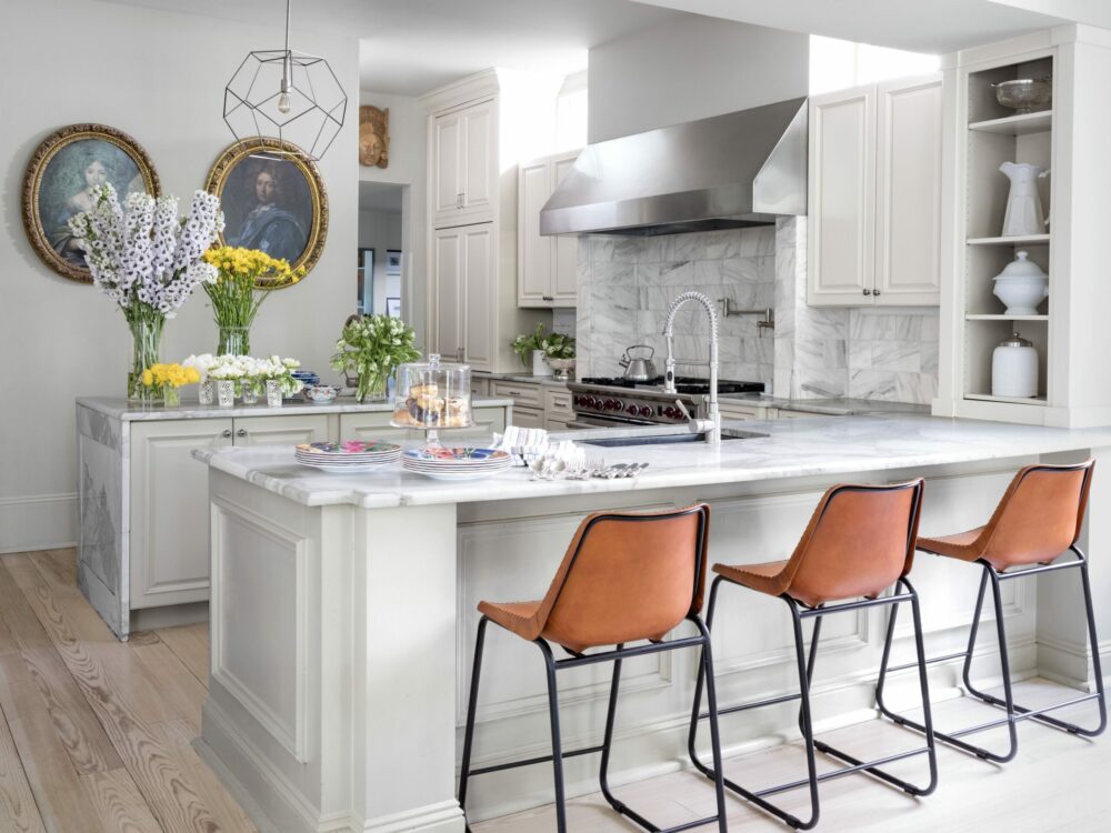 a white peninsula shaped kitchen