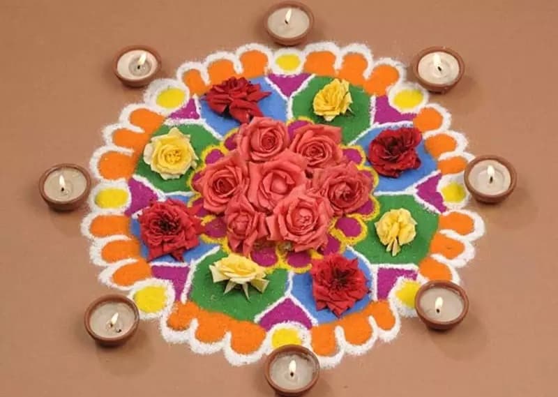 rangoli design with candles and flowers