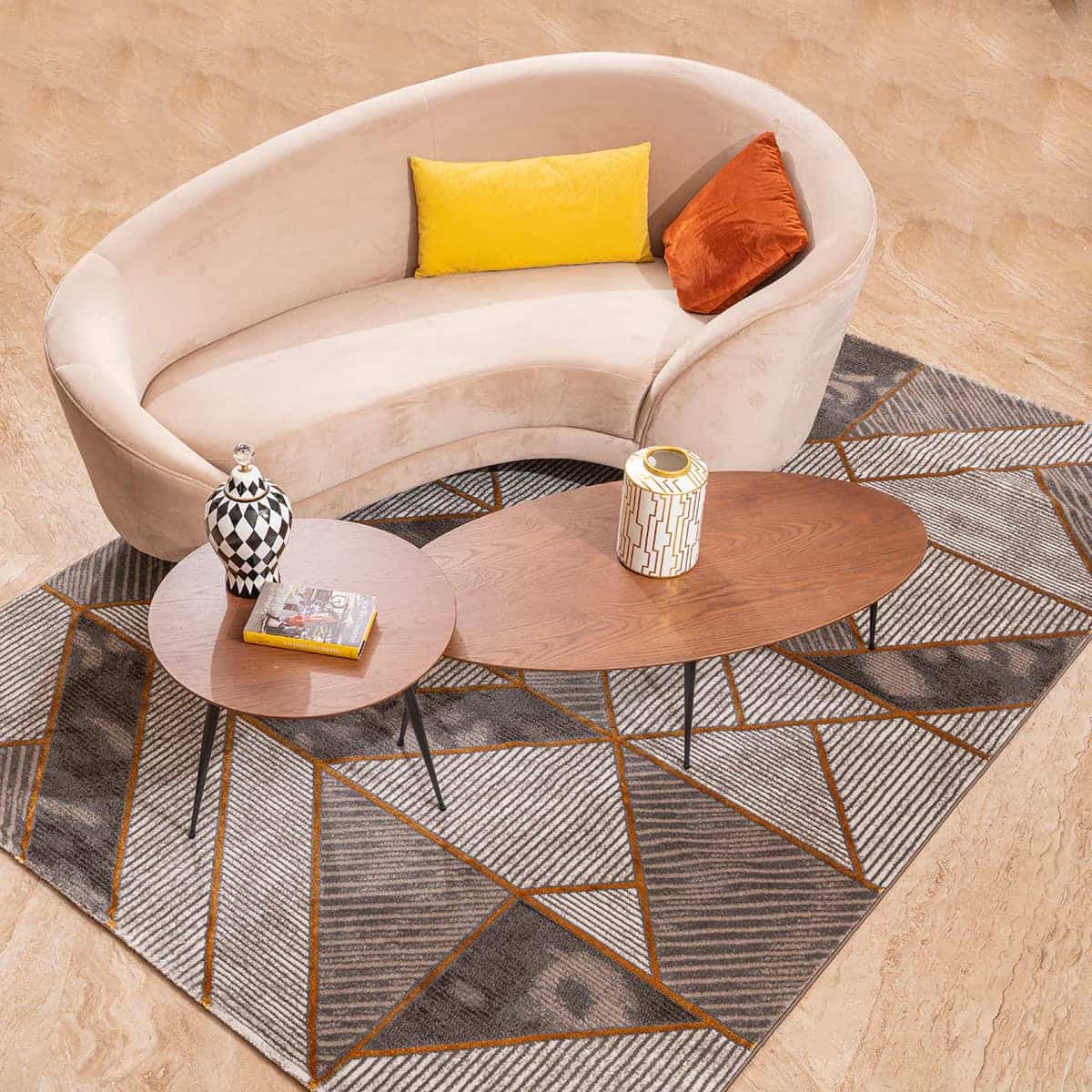 beige sofa, reclaimed wood oval shaped coffee table, with sleek metal legs , cushions, wood flooring, scandinavian styled table, book, carpet