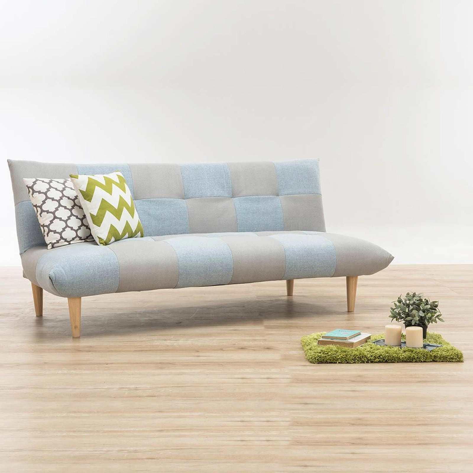 fabric futon, with sleek wood legs, cushions, wood flooring, white walls, classic vibe, minimalistic look