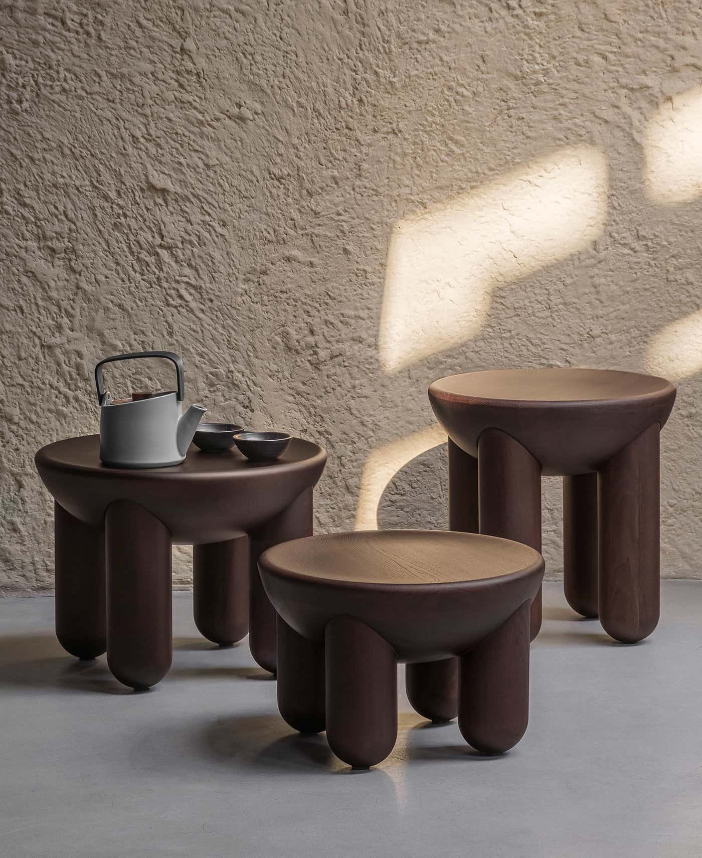 round mid-century centre piece, with dark brown wood, giving a glossy and traditional appeal to your ،e, a kettle and cup 