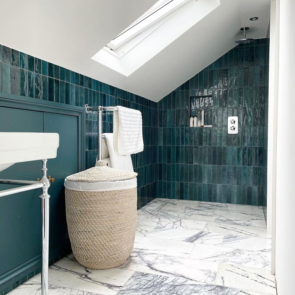 compact restroom with skylight, glossy tiles giving it a gorgeous and larger appearance