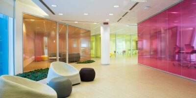 Different types of toughened or tempered glass in orange, pink and yellow in an office