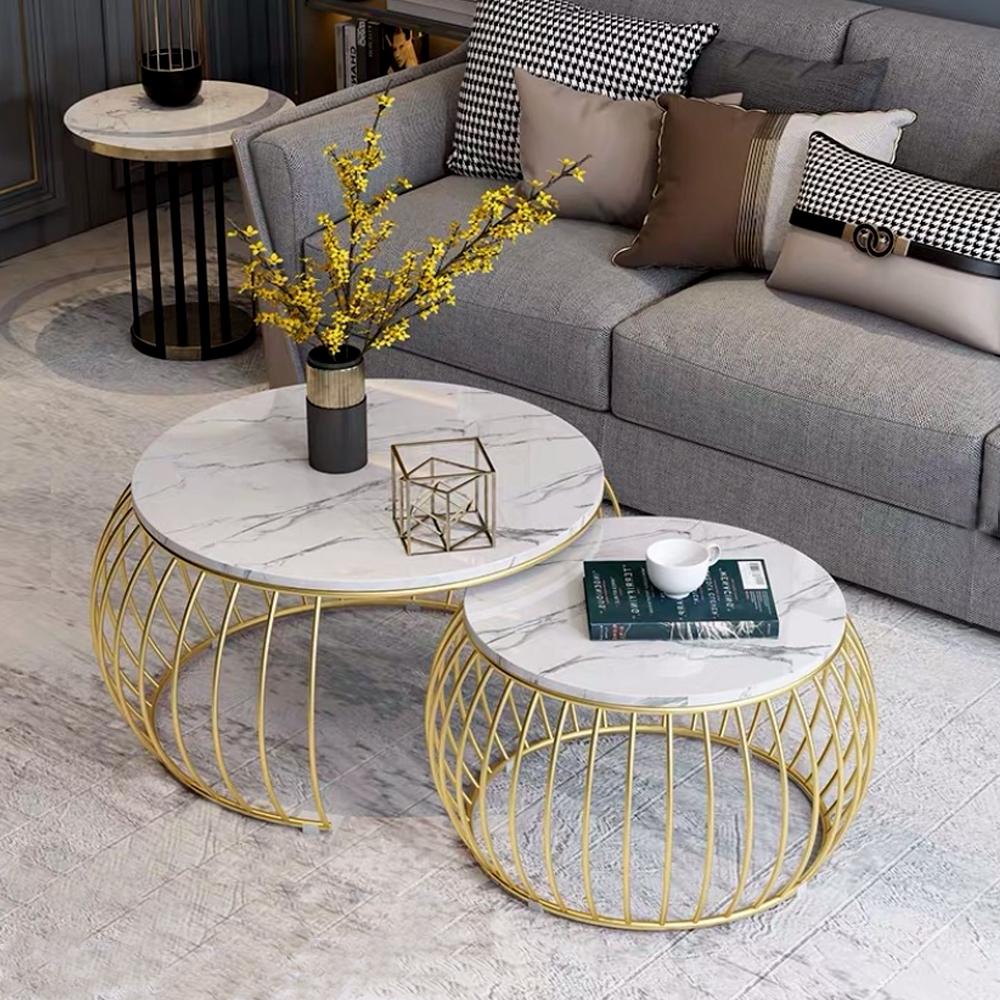 beautiful centre piece with gold faux caged body, white marble table top, grey sofa, grey tiled floor, cushions, book on table top, artificial flower decorative piece