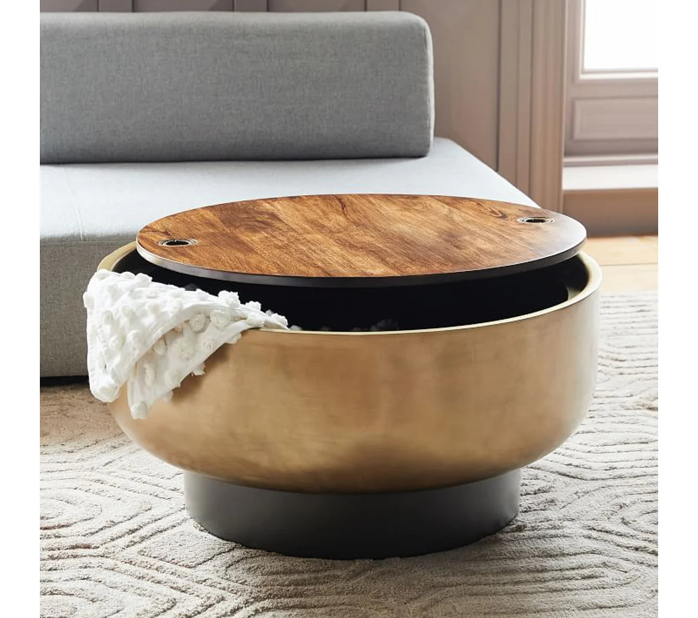 round drum shaped coffee table with reclaimed wood lid, with storage space inside , beige carpet, grey sofa, minimal living room with classic vibe