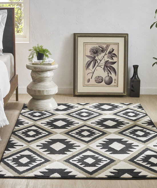 4x6 area rug, placed in a bedroom, black and beige coloured carpet 