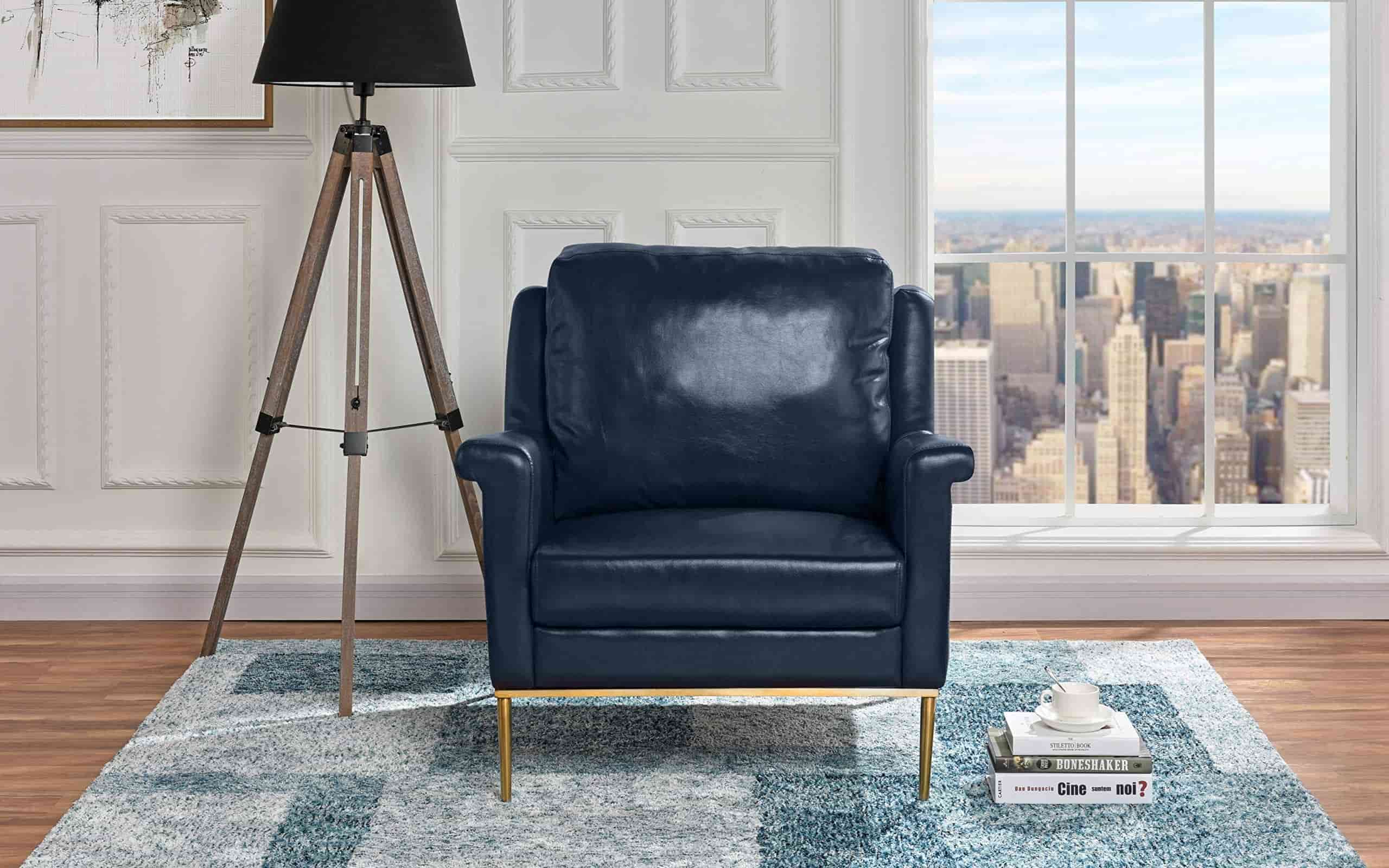 blue coloured modern club chair, placed in hall, rug placed on floor, tall lamp besides the seat