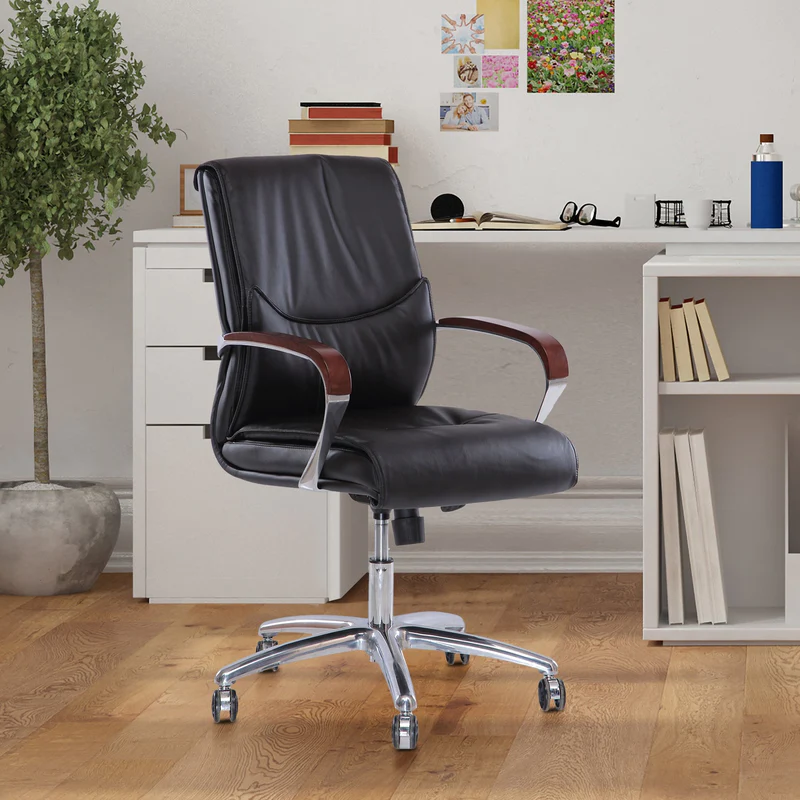 black coloured office seat on wheels with swivel function, white desk in a room, wooden flooring, indoor plant