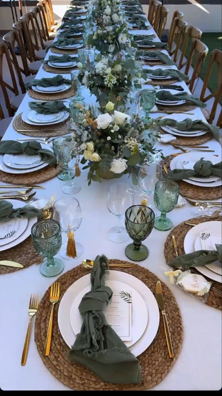 white tablecloth on a dining table with cutlery, plates, glasses, napkin, chairs and dining table