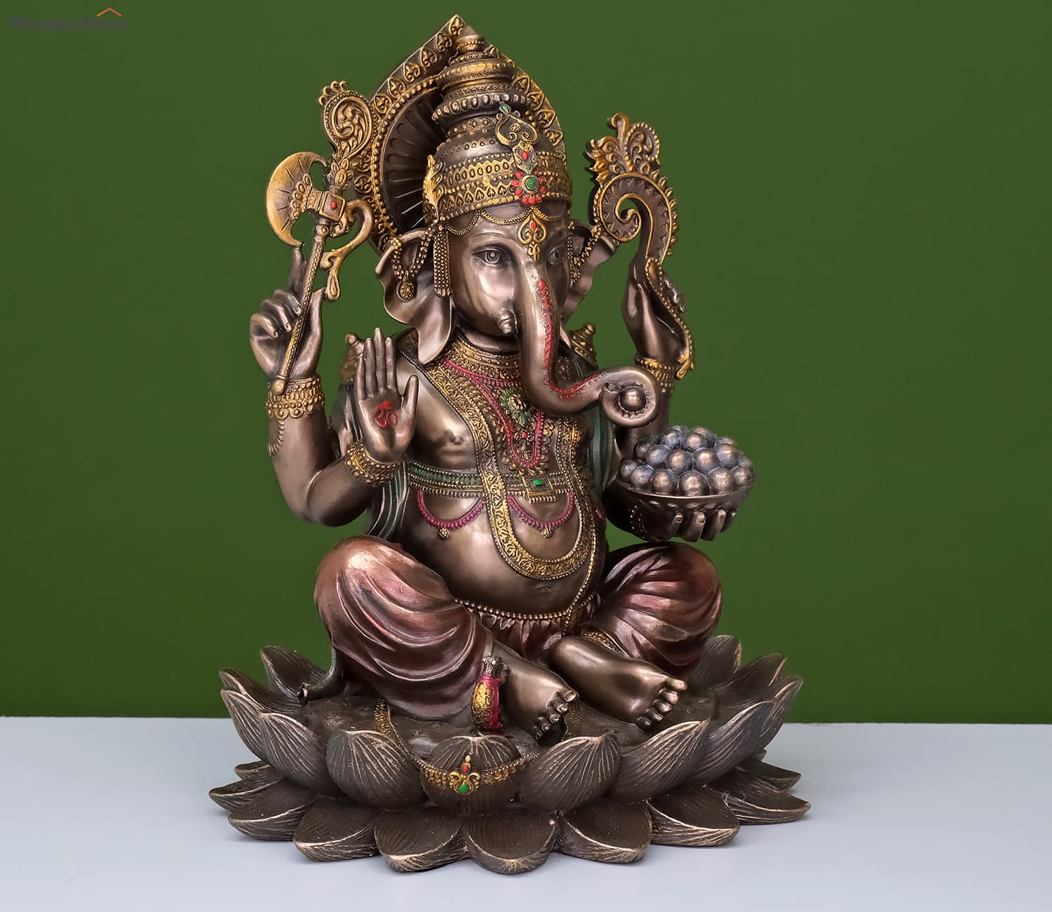 bronze Ganapati murti sitting on a lotus, with beautiful carvings