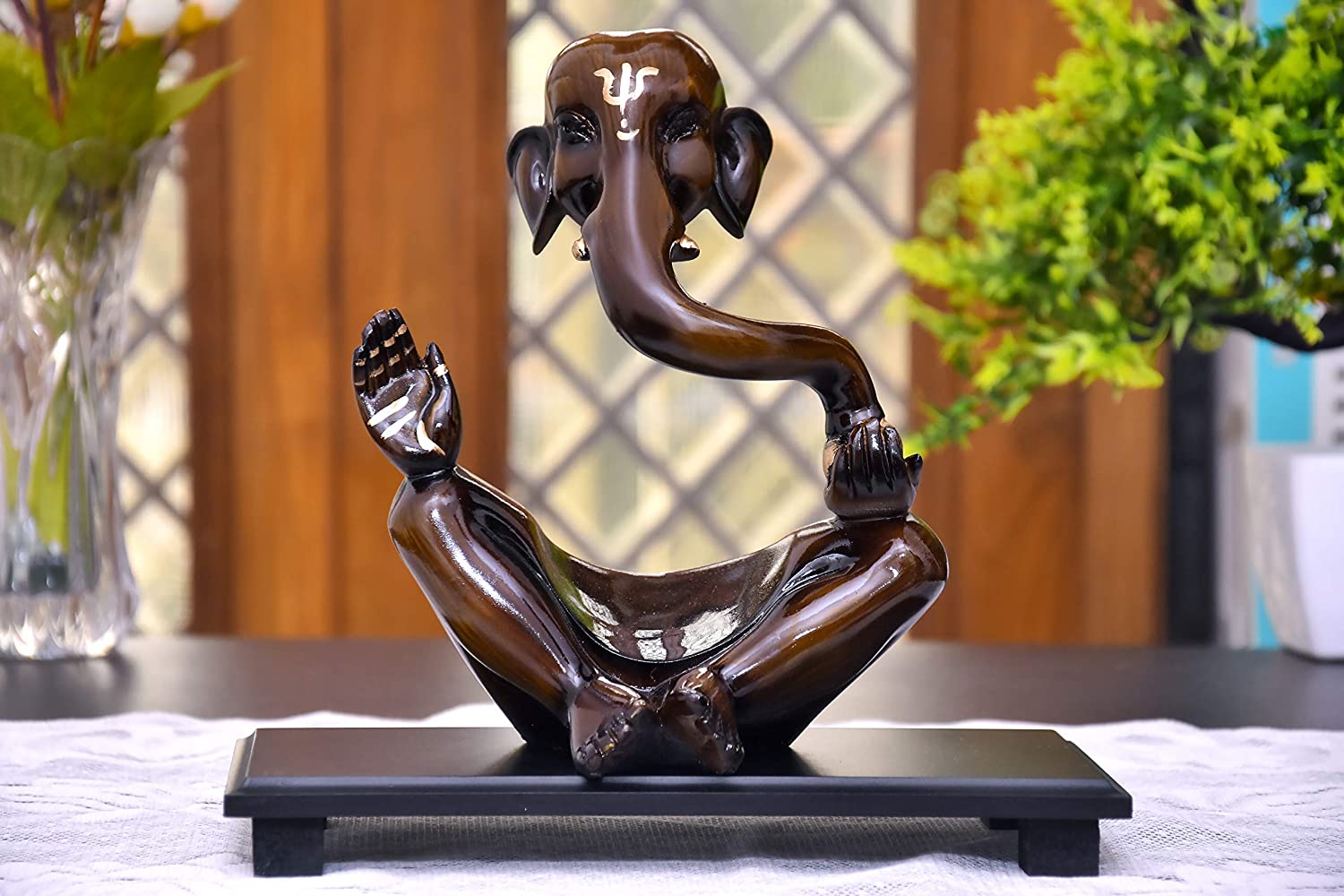 Ganpati idol made of ceramic, placed in living room, enhances home decoration