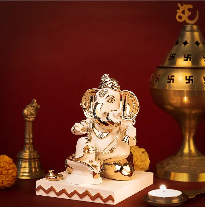 Divine idol of Lord Ganapati praying to a Shiva Linga, crafted in resin and marble dust with gold plated petals. 