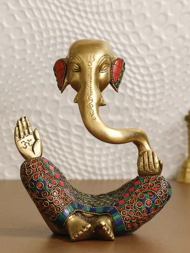 handcrafted brass Ganesha idol or photo with colourful stone work which reflects the artistic brilliance and adds elegance to your decor. 