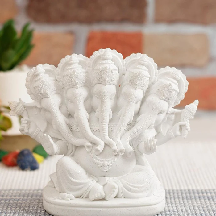 white ganpati murti photo, panchmukhi ganpati, placed on a table