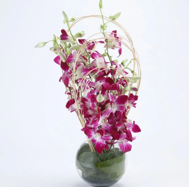 beautiful pink flowers, placed in a glass planter