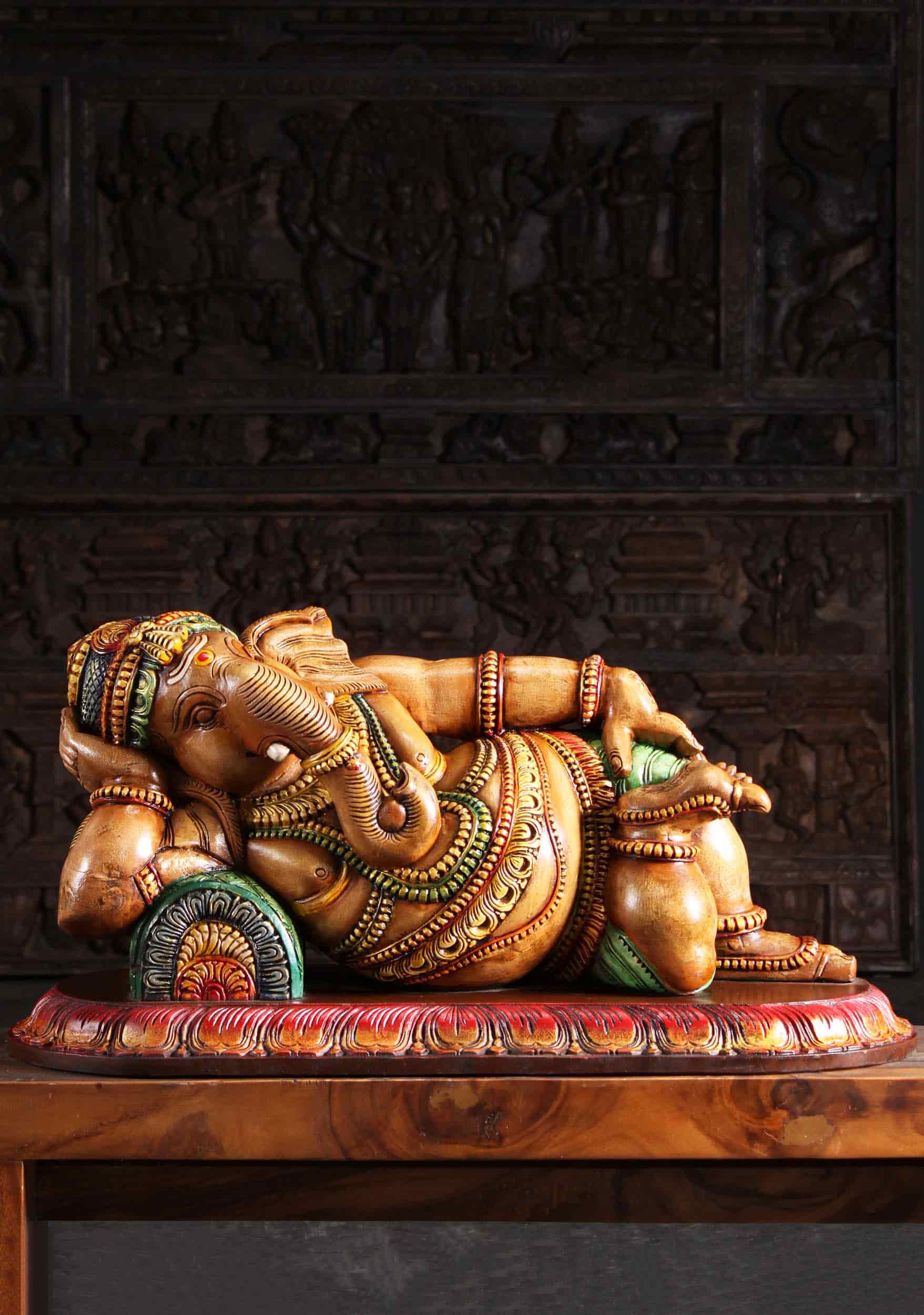 Ganapati figurine in a relaing posture, figurine made of wood intricate with beautiful carvings