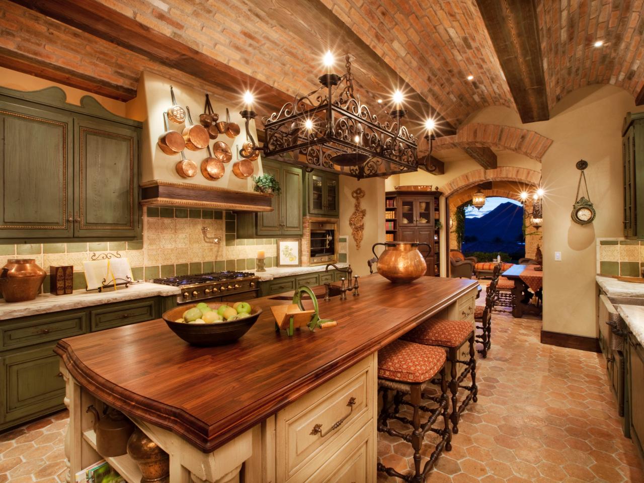brown tuscan style kitchen with best kitchen cabinet colours ideas with kitchen island, chairs, chandelier, chimner and wooden floors 