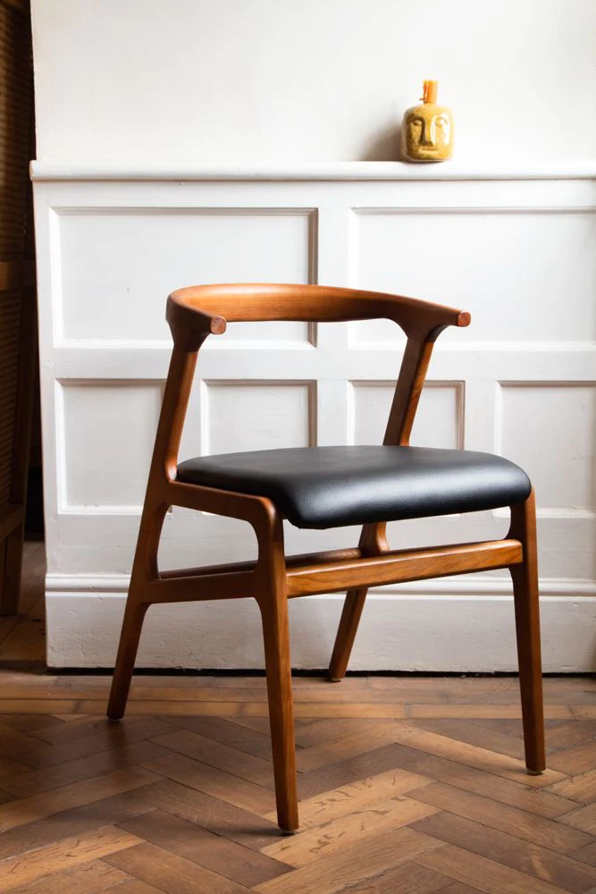 wooden body modern chair, placed in a room, wooden flooring, wall decor, white table