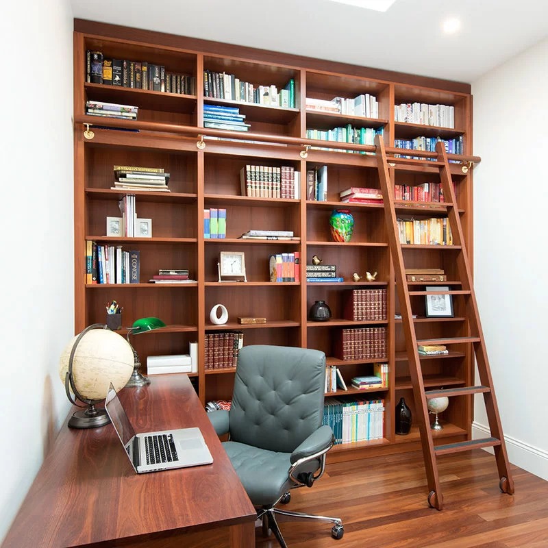 built-in bookshelf in a home office, storage for books can be placed in bedroom, wooden furniture, chair, table
