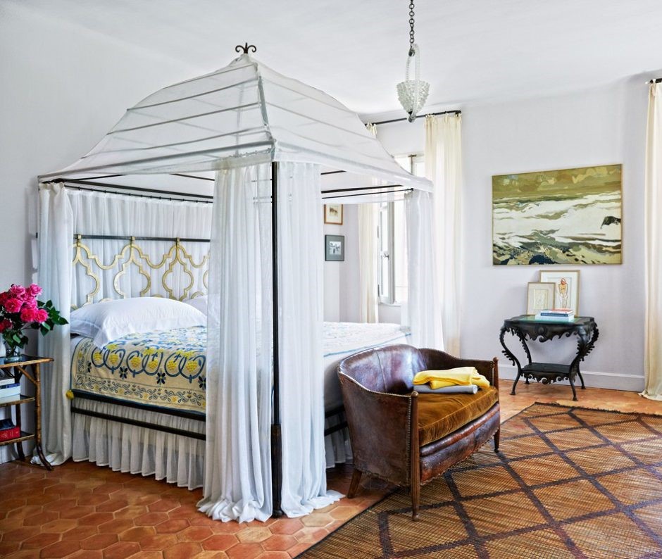 minimalist bedroom interior design with wrought iron canopy bed with white french linens and drapery