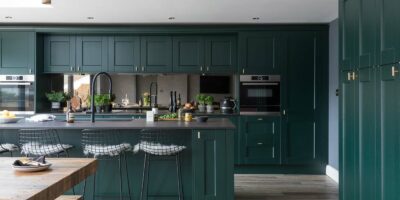 dark green shaker kitchen cabinets and island with stainless steel appliances